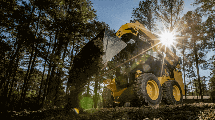 A skid steer in use on a job site